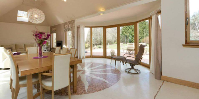 A magnificent, double-height open plan kitchen, dining and living area with opulent ‘venetian-style’ flooring.