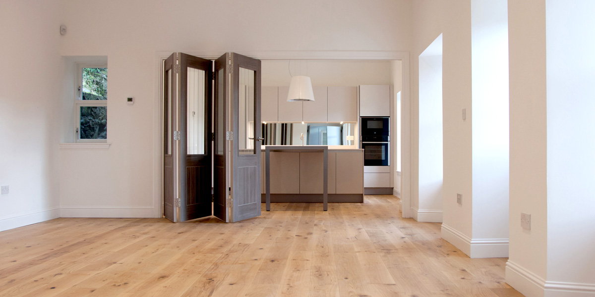 Open plan kitchen/dining/living room featuring triple bay window formation.